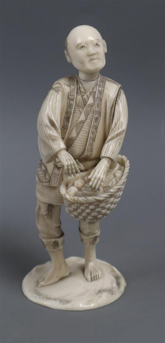 A Japanese carved ivory figure fruit seller H.16cm